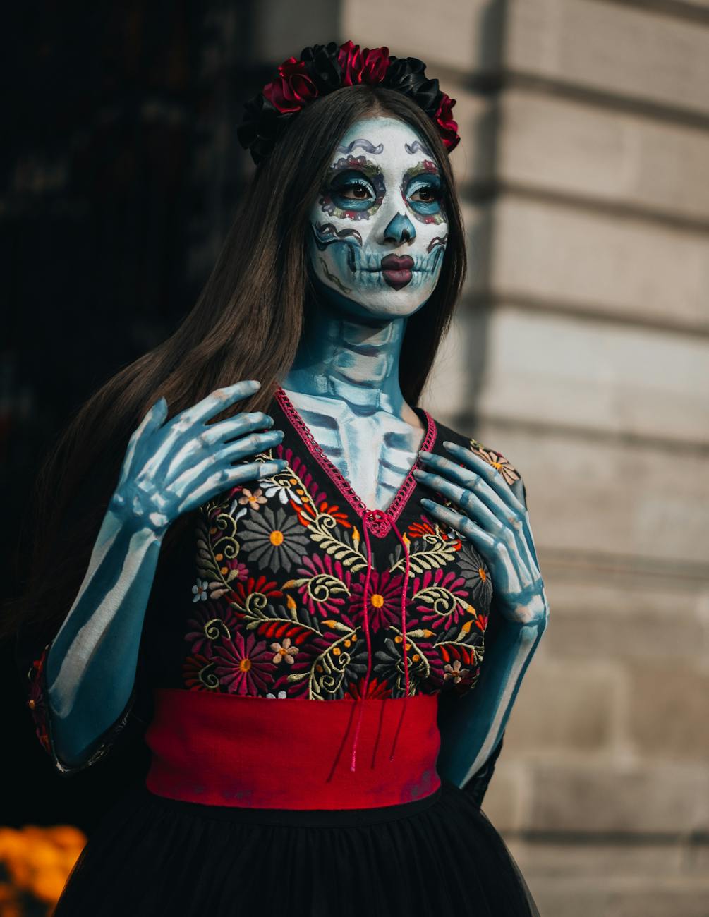 Woman in Day of the Dead makeup and costume, colorful and detailed. [pexels]